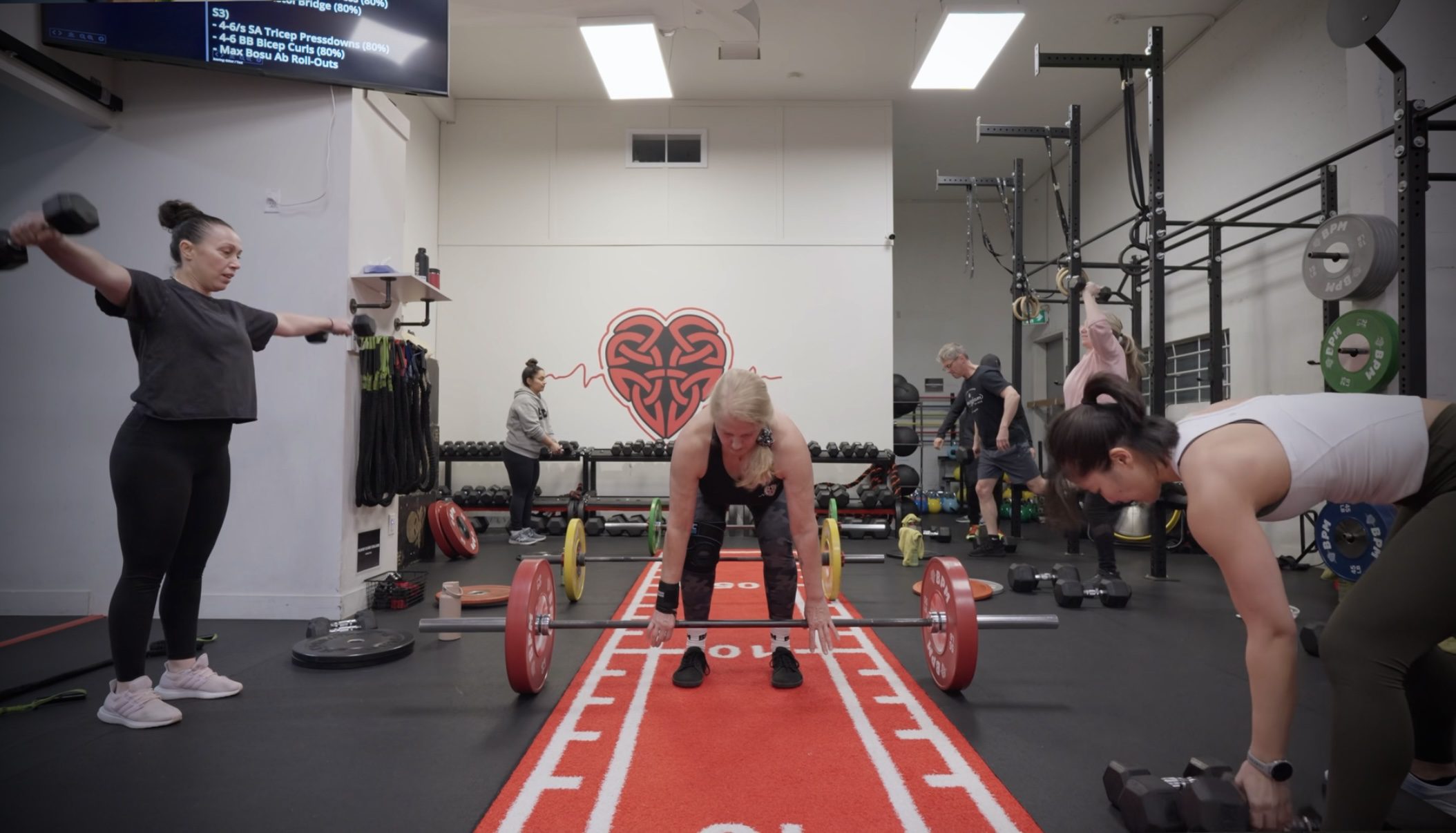 Female Personal Training Client Deadlifting a barbell at BPM Fitness Centre in Victoria BC